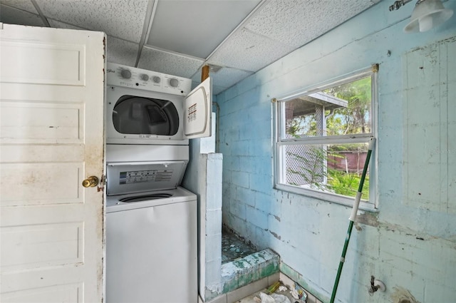 washroom featuring stacked washer / dryer