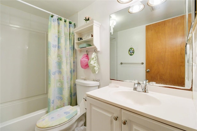 full bathroom featuring vanity, shower / bath combination with curtain, and toilet