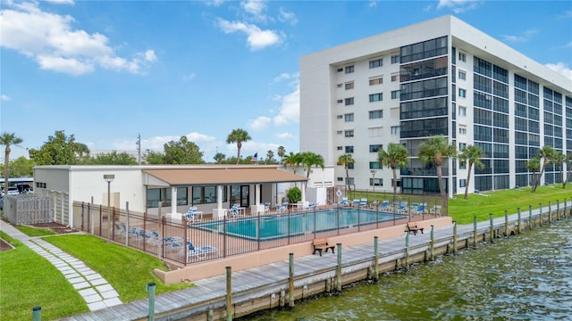 view of pool with a patio and a water view