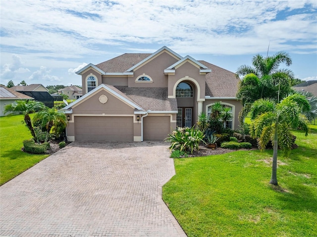 view of front of house with a garage and a front yard