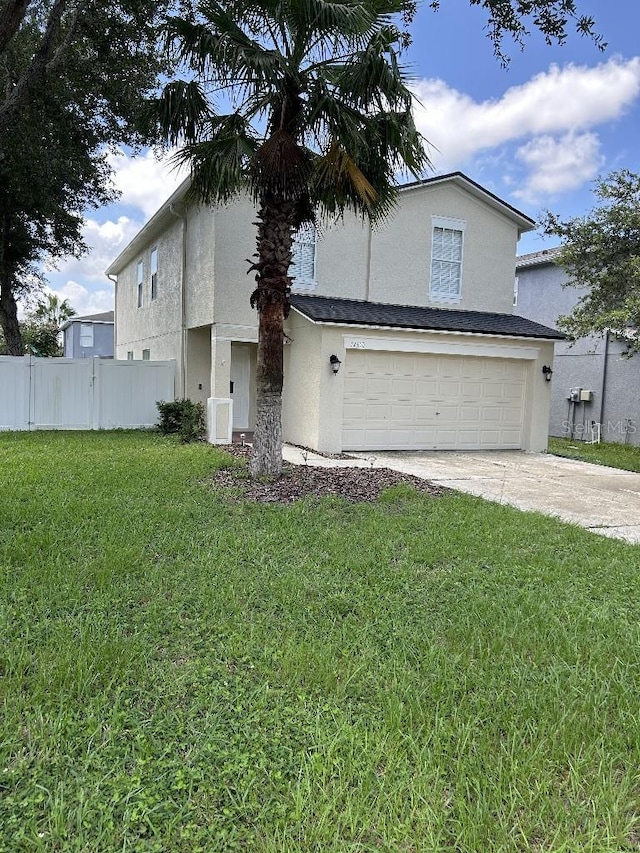 view of front of property with a garage and a front yard