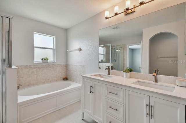 bathroom featuring vanity, independent shower and bath, and tile patterned flooring