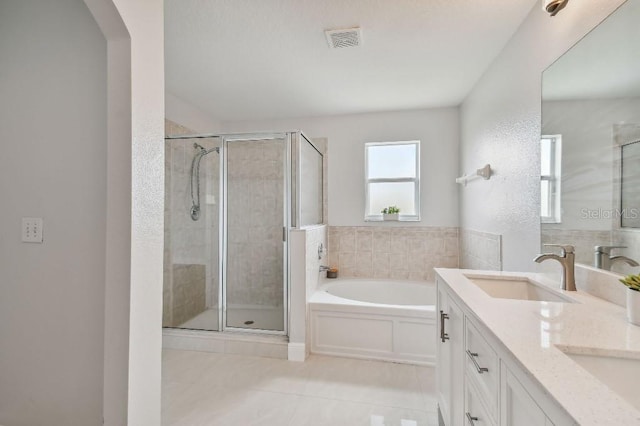 bathroom featuring tile patterned floors, separate shower and tub, and vanity