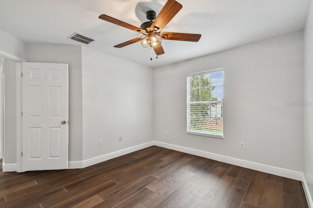 unfurnished room with dark hardwood / wood-style flooring and ceiling fan