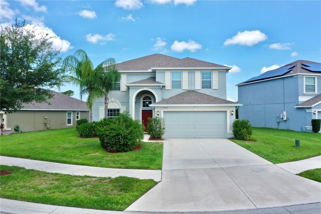 view of front of house featuring a garage and a front lawn