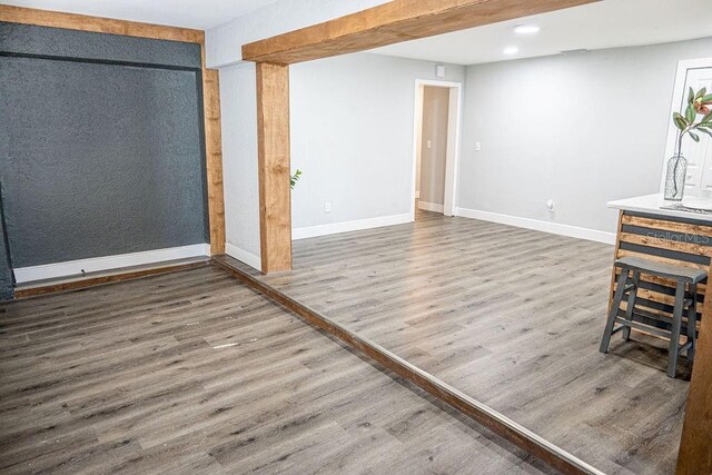 unfurnished living room with wood-type flooring