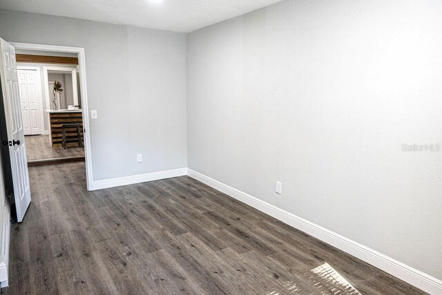 spare room with dark hardwood / wood-style flooring