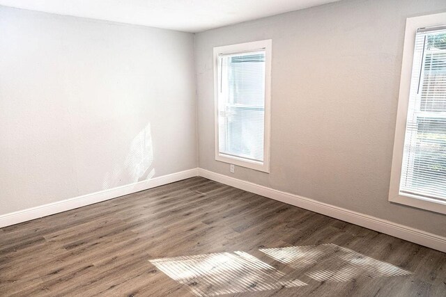 empty room with hardwood / wood-style floors