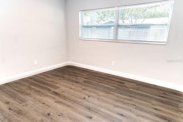 spare room featuring dark hardwood / wood-style flooring