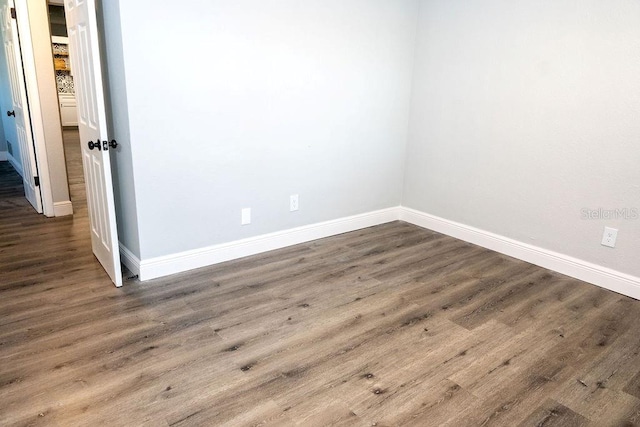 empty room with hardwood / wood-style flooring