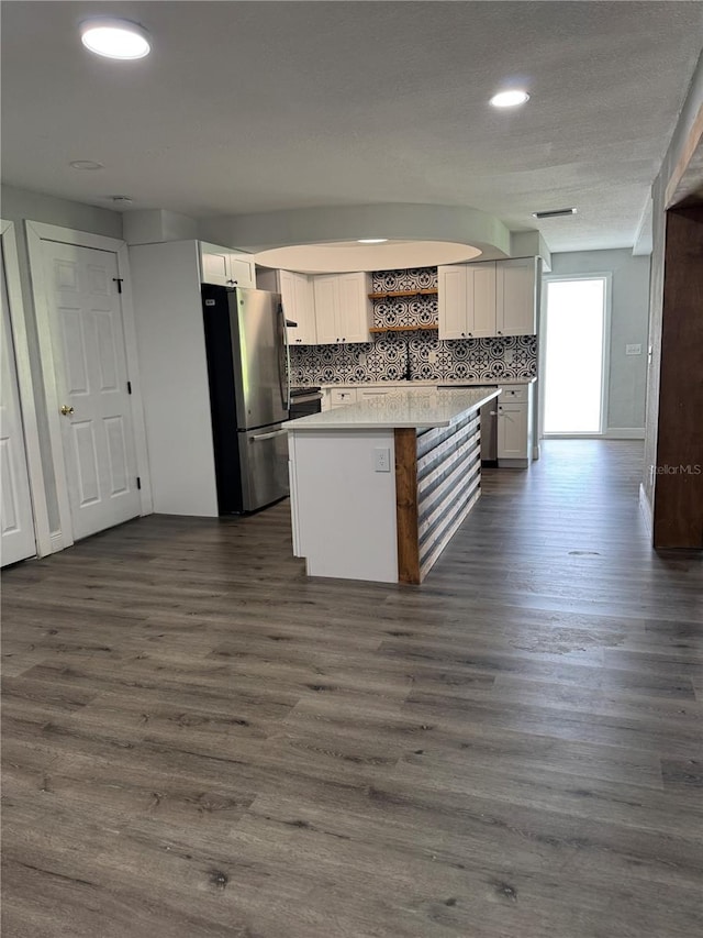 kitchen with freestanding refrigerator, dark wood-style flooring, backsplash, and open shelves