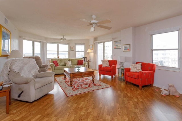 living room featuring light wood-type flooring and ceiling fan