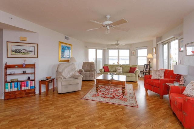 living room featuring light hardwood / wood-style flooring and ceiling fan