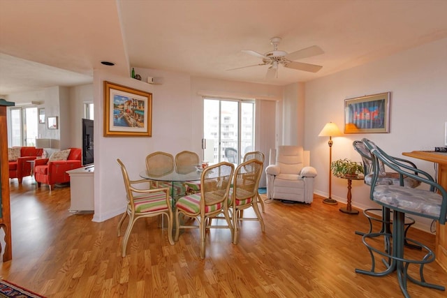 dining area featuring light hardwood / wood-style flooring and ceiling fan