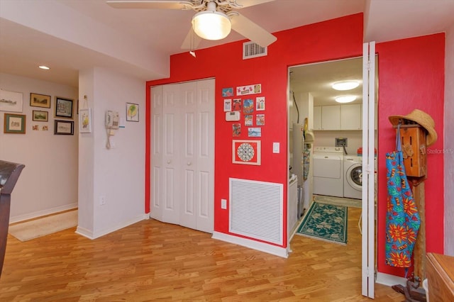 1 John Anderson Dr Unit 604, Ormond Beach, FL 32176 - interior space featuring light wood finished floors, baseboards, separate washer and dryer, and visible vents