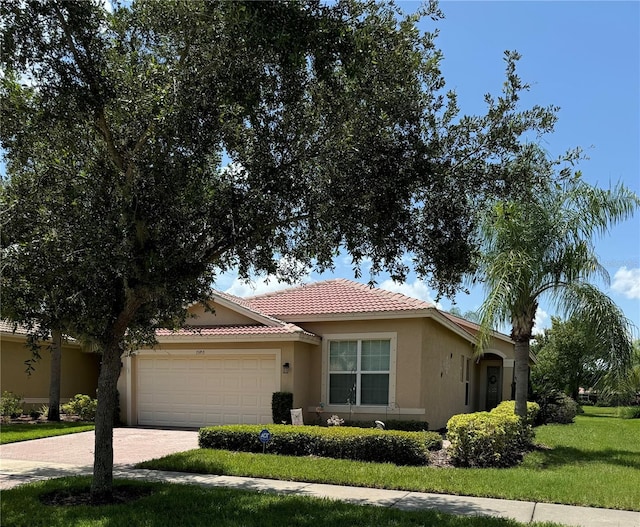 view of front of house with a garage and a front lawn