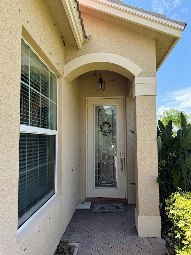 doorway to property with stucco siding