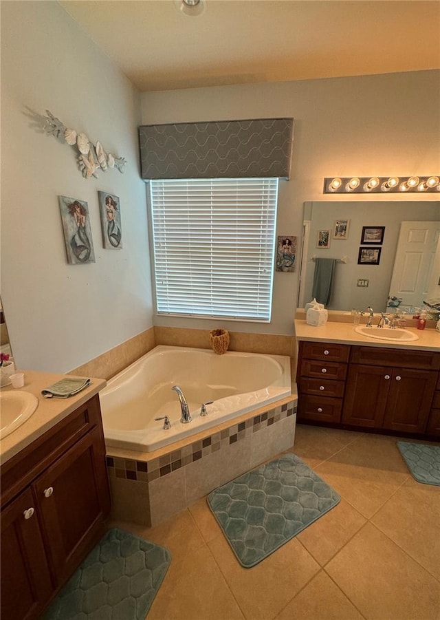 bathroom with a sink, a garden tub, two vanities, and tile patterned floors