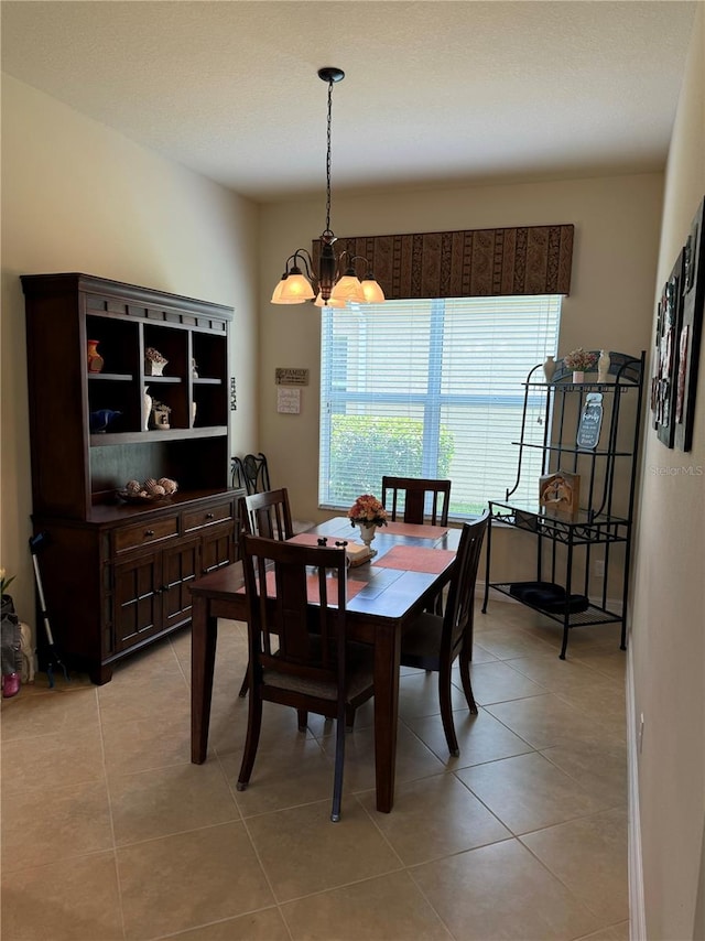 dining area with an inviting chandelier and light tile patterned floors