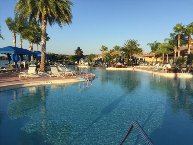 view of swimming pool featuring a water view