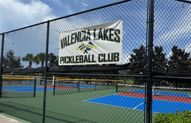 view of sport court featuring fence