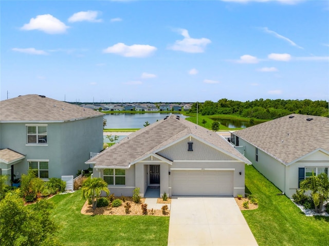 view of front of house featuring a water view, a garage, and a front lawn