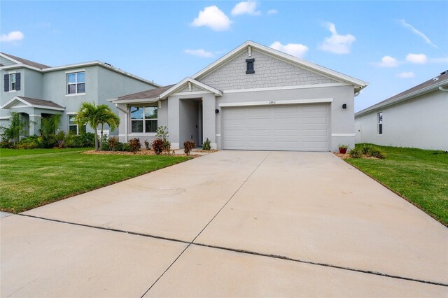 view of front of home with a garage and a front yard