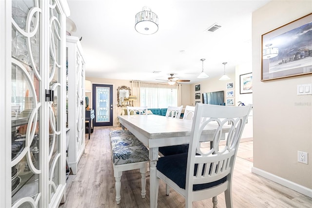 dining room featuring light hardwood / wood-style flooring and ceiling fan