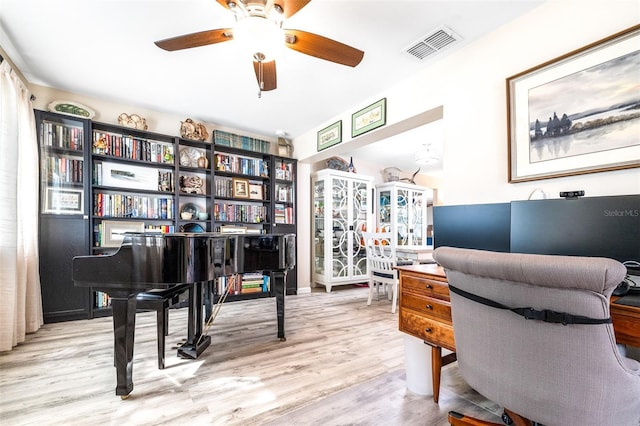 office area with light hardwood / wood-style floors and ceiling fan