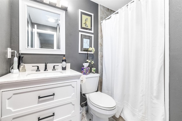 bathroom featuring toilet and vanity