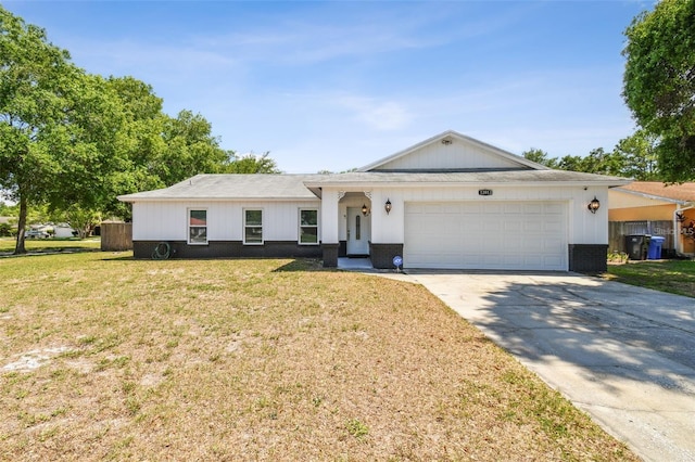 single story home featuring a garage and a front lawn