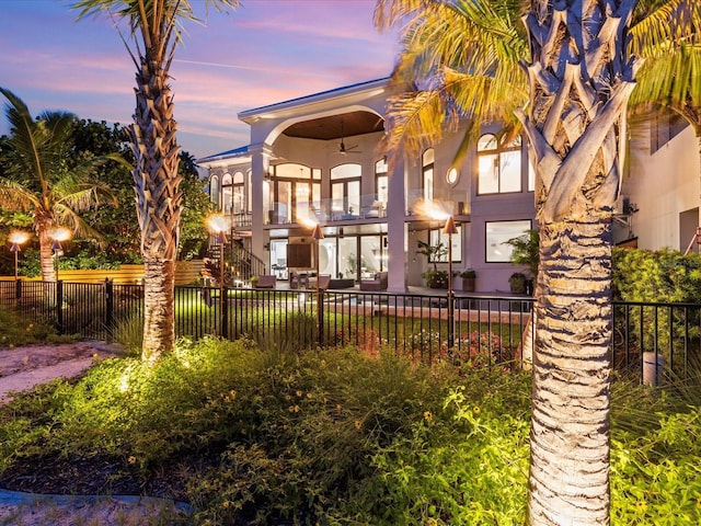 exterior space featuring ceiling fan and a balcony