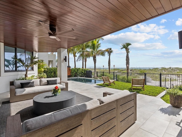 view of patio with ceiling fan, an outdoor hangout area, and a fenced in pool