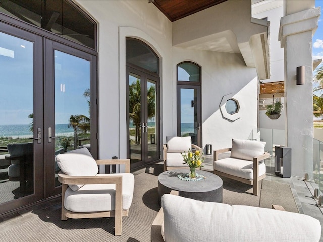 view of patio / terrace with a water view and french doors