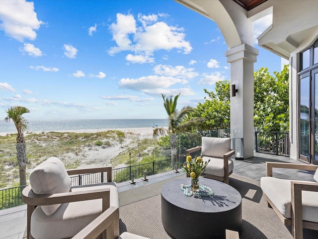 view of patio with a balcony and a water view