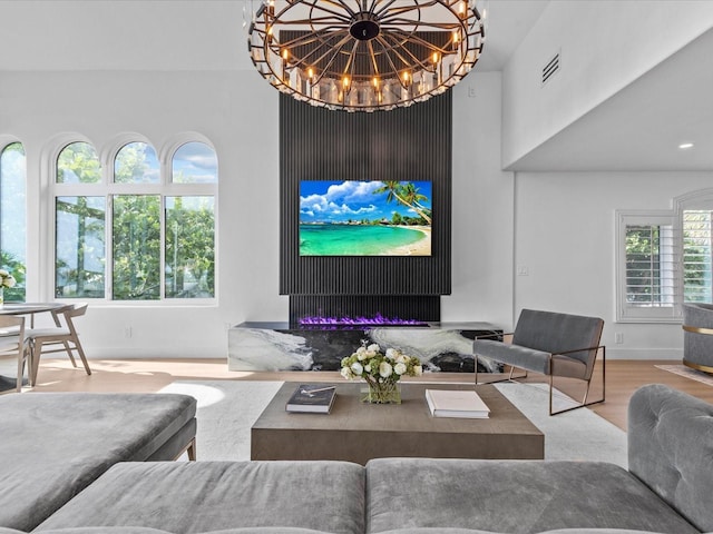 living room with a towering ceiling and wood-type flooring