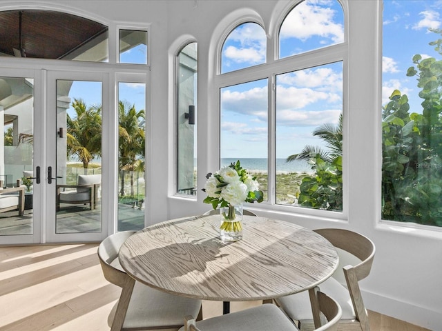 sunroom / solarium featuring a water view