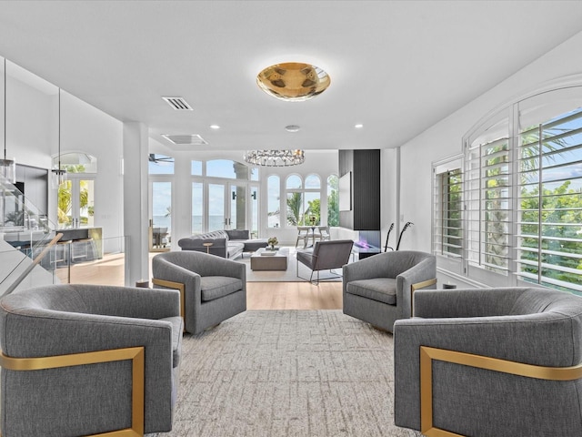 living room with a water view and light wood-type flooring