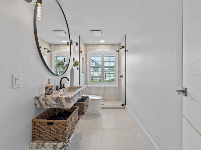 bathroom with an enclosed shower, sink, and toilet