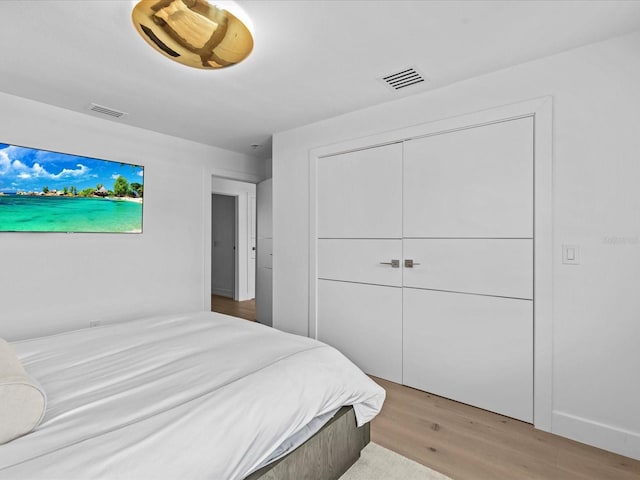 bedroom featuring light hardwood / wood-style floors and a closet