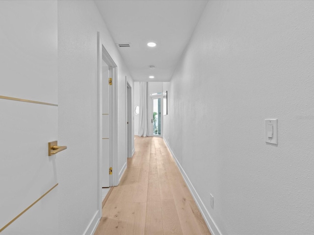 hallway with light wood-type flooring