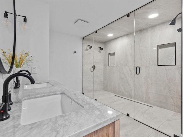 bathroom with vanity and a shower with shower door