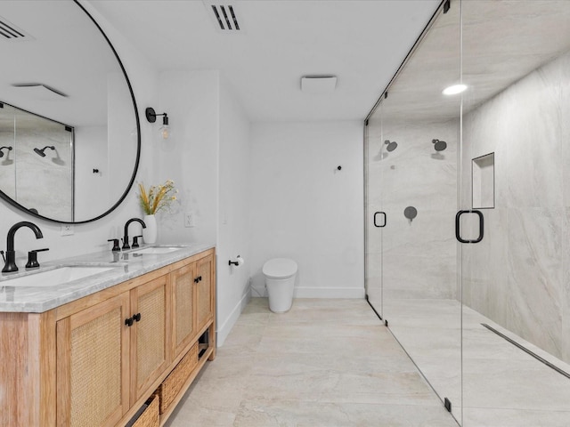 bathroom with vanity, a shower with door, and toilet