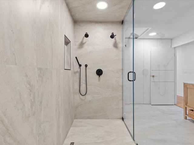 bathroom featuring a shower with shower door