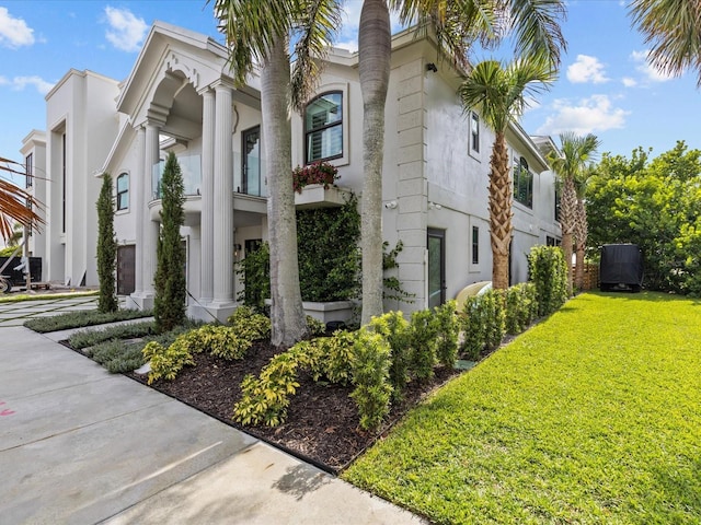 view of side of home featuring a lawn