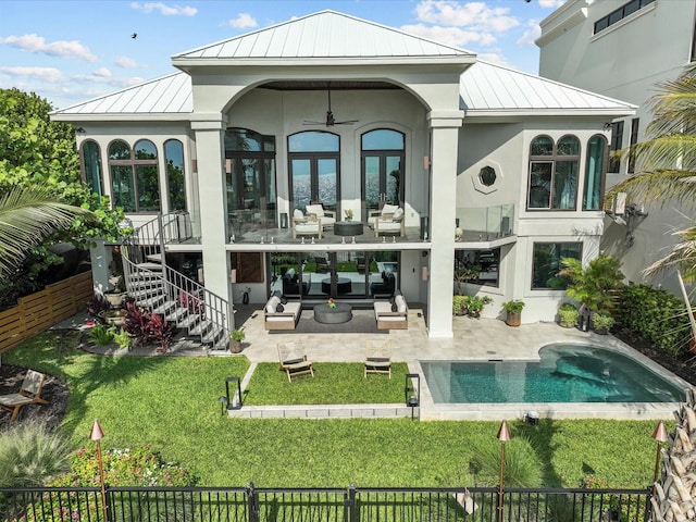 back of house with a patio area, a lawn, outdoor lounge area, ceiling fan, and a fenced in pool