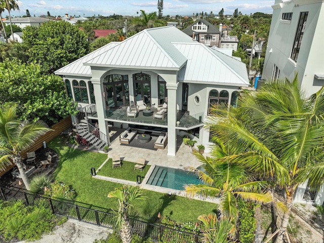 exterior space featuring outdoor lounge area and a fenced in pool