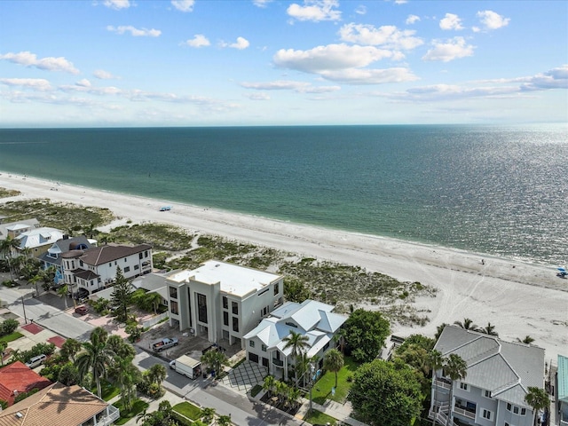 bird's eye view featuring a water view and a beach view