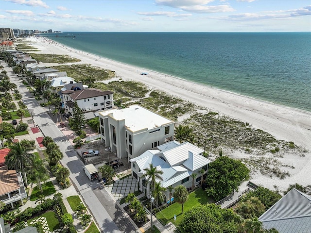 drone / aerial view with a water view and a beach view