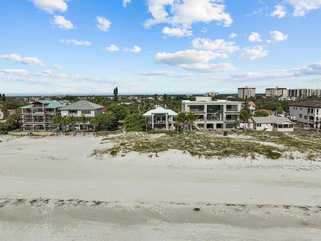 drone / aerial view featuring a water view and a beach view